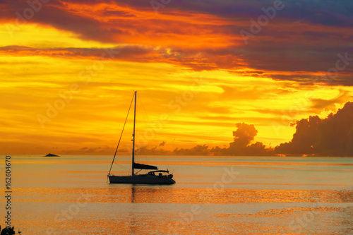 Sunset in sea and sailing yacht silhouette with beautiful landscape of Caribbean, Santa Lucia island 