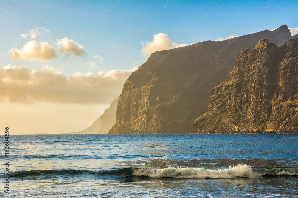 Amazing view from beach in Los Gigantes with high cliffs on the sunset. Location: Los Gigantes, Tenerife, Canary Islands. Artistic picture. Beauty world. Amazing view from beach in Los Gigantes with high cliffs on the sunset. Location: Los Gigantes, Tenerife, Canary Islands. Artistic picture. Beauty world.