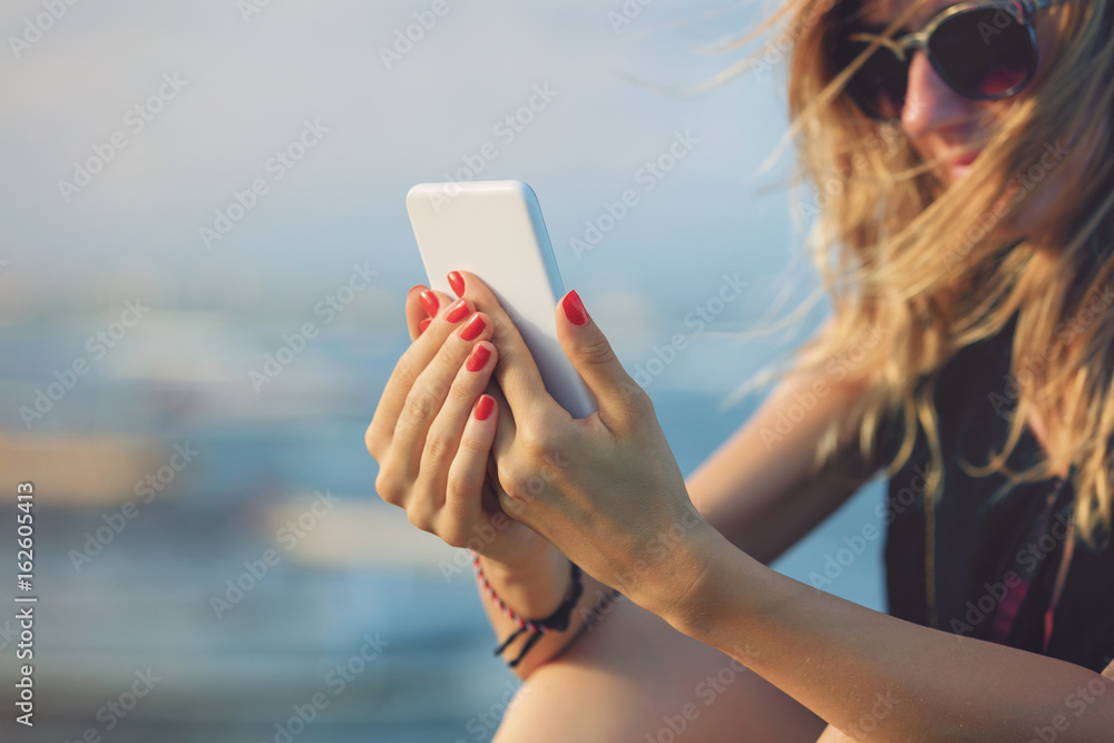 Woman using her smartphone outdoors.