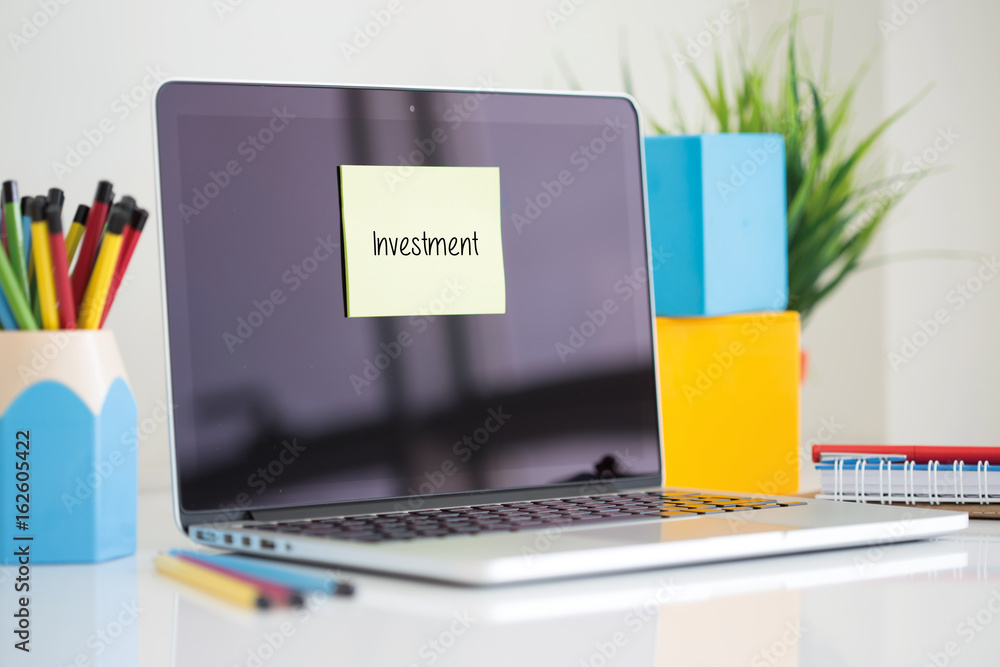 Investment sticky note pasted on the laptop Investment sticky note pasted on the laptop