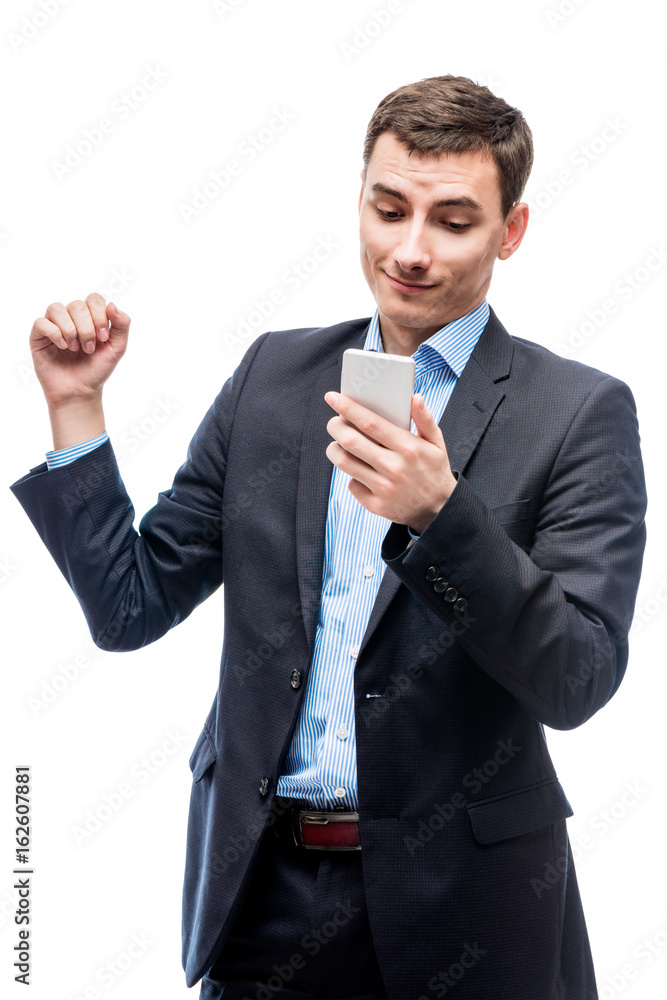 Joyful successful businessman with a phone in hands on a white background Joyful successful businessman with a phone in hands on a white background