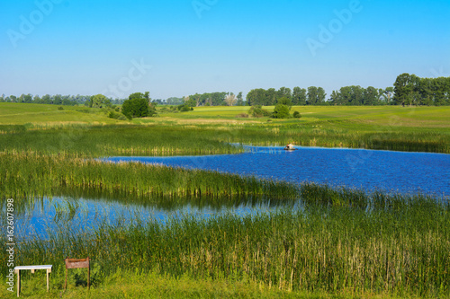 Fototapeta Naklejka Na Ścianę i Meble -  A beautiful lake for breeding fish. Magnificent view of the lake.
