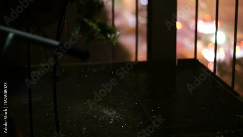 Wallpaper Mural (slow motion) Pouring raindrops on stairs and out of focus traffic illumination in the background. Torontodigital.ca