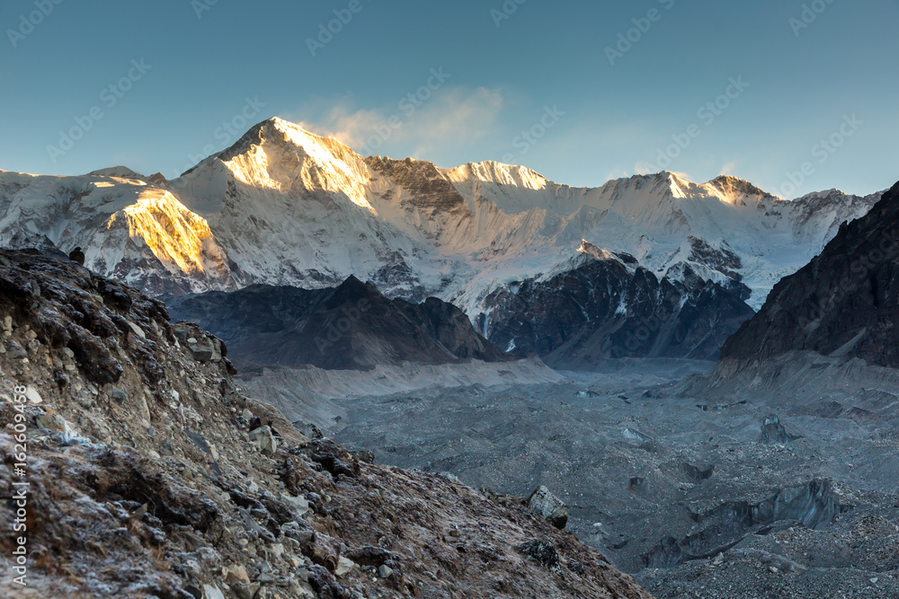 Ngozumpa glacier and Cho Oyu mount in a sunrise light, a border between Nepal and Tibet, view from Gokyo valley. 