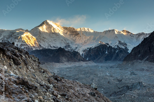 Ngozumpa glacier and Cho Oyu mount in a sunrise light, a border between Nepal and Tibet, view from Gokyo valley.  photo
