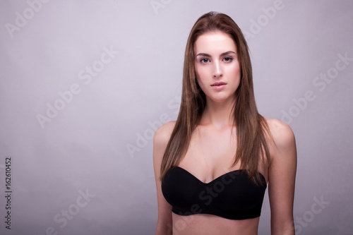 Wallpaper Mural Gorgeous woman in bra with natural make up on gray background in studio photo. Beauty and fashion. Torontodigital.ca