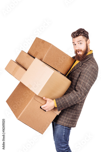 Man hardly carries the cardboard boxes, isolated on white background. © kaninstudio
