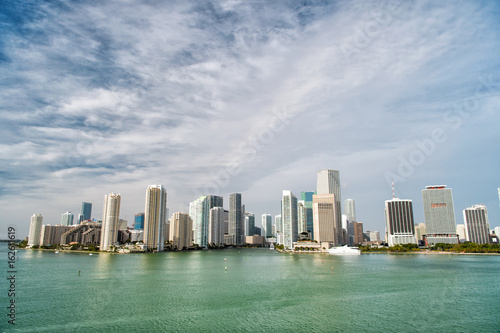 Miami skyscrapers with blue cloudy sky  boat sail  Aerial view