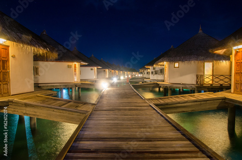 A night scene of sea bungalows at Maldives