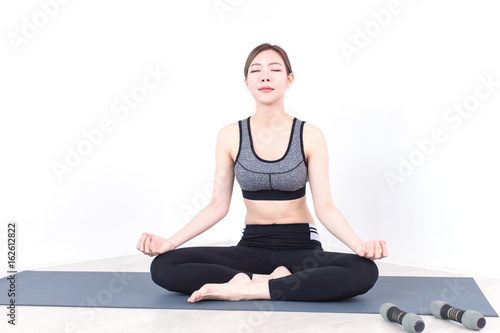Fototapeta Naklejka Na Ścianę i Meble -  Young Fitness Asian woman doing yoga exercise in bedroom
