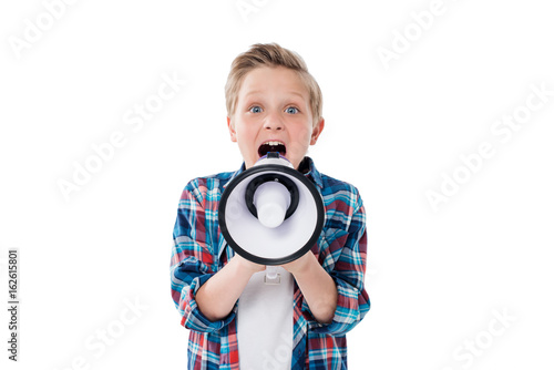 Cute little boy screaming in megaphone and looking at camera © LIGHTFIELD STUDIOS