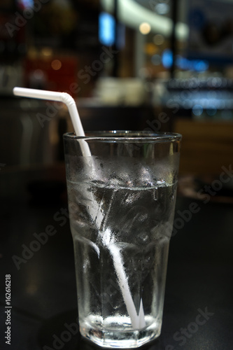 cold and pure drinking water with white straw. photo