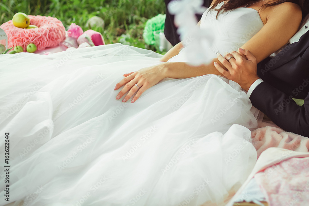 Fototapeta premium Man's hand holding woman's hand gently on green background