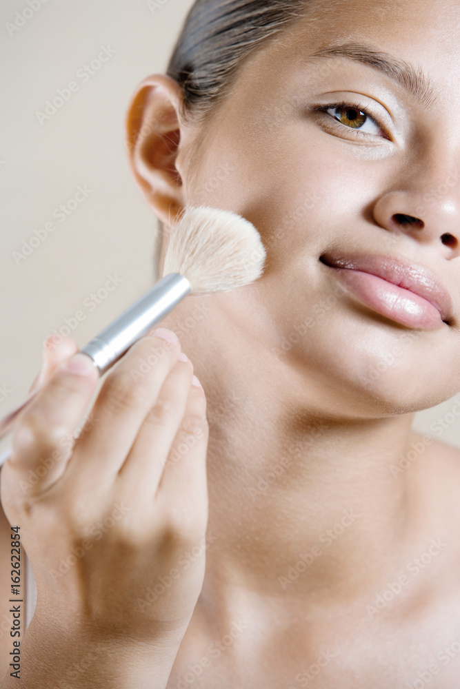 Fotografie Girl applying face powder