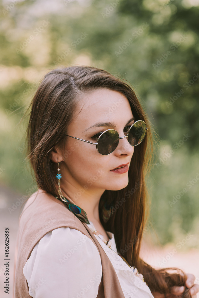 A portrait of beautiful dark hair hippie girl wearing bo ho clothes and dark sunglasses, posing in the park. вспомогательное оборудованиеpritiaghatiel nyiprivliekatiel noprivliekatiel nyiпривлекатель A portrait of beautiful dark hair hippie girl wearing bo ho clothes and dark sunglasses, posing in the park. вспомогательное оборудованиеpritiaghatiel nyiprivliekatiel noprivliekatiel nyiпривлекатель