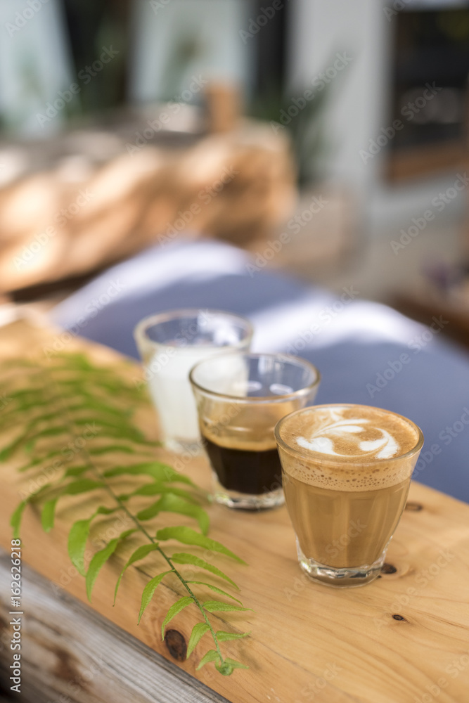 The ingredients of coffee on a wooden desk The ingredients of coffee on a wooden desk