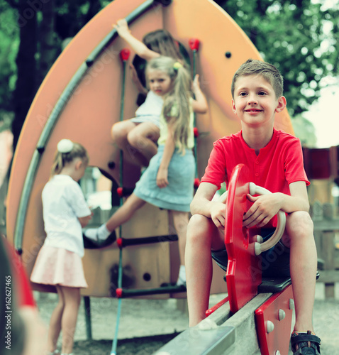 cheerful boy on children's playground.
