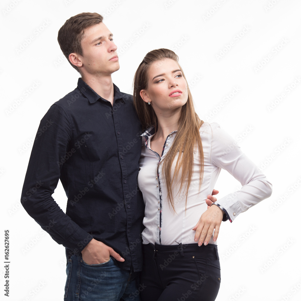 Young pensive couple portrait of a confident businessmanon a gray background. Ideal for banners, registration forms, presentation, landings, presenting concept. Young pensive couple portrait of a confident businessmanon a gray background. Ideal for banners, registration forms, presentation, landings, presenting concept.