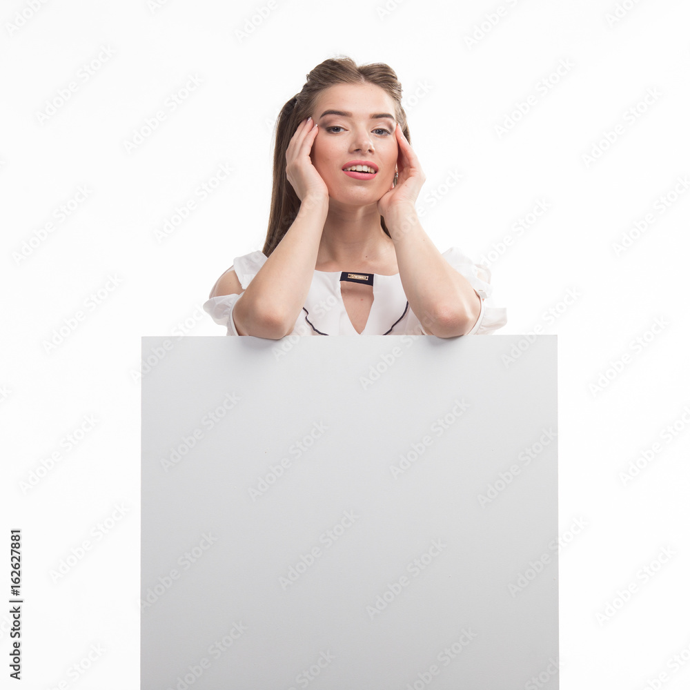 Young happy woman portrait of a confident businesswoman showing presentation, pointing placard gray background. Ideal for banners, registration forms, presentation, landings, presenting concept.. Young happy woman portrait of a confident businesswoman showing presentation, pointing placard gray background. Ideal for banners, registration forms, presentation, landings, presenting concept..