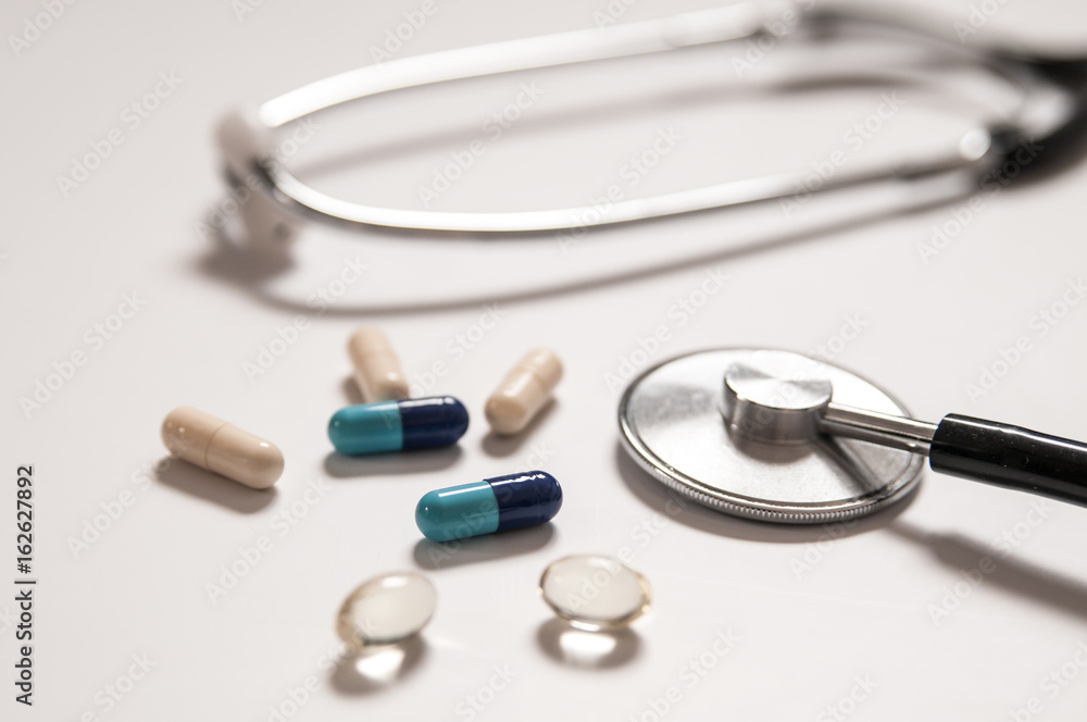 stethoscope on white background with mix pills isolated stethoscope on white background with mix pills isolated