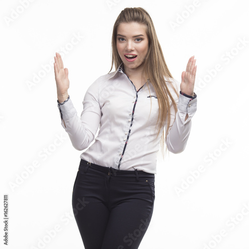 Young happy woman portrait of a confident businesswoman showing presentation, pointing placard gray background. Ideal for banners, registration forms, presentation, landings, presenting concept..