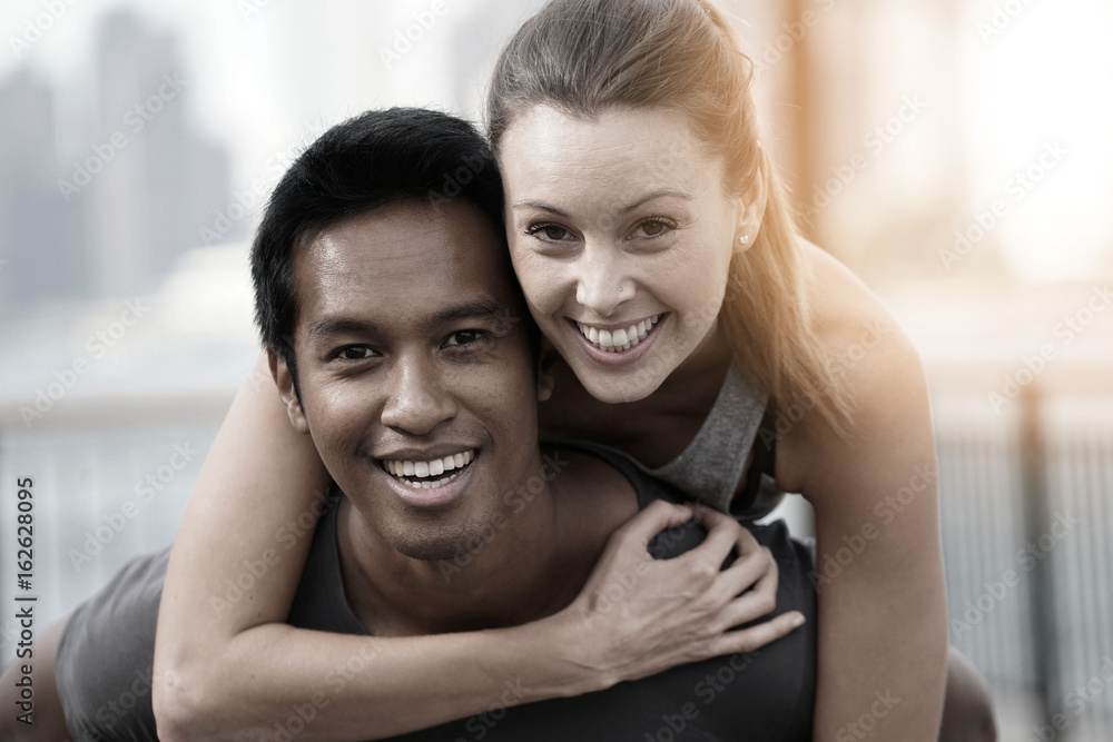 Fototapeta premium Man giving piggyback ride to girlfriend