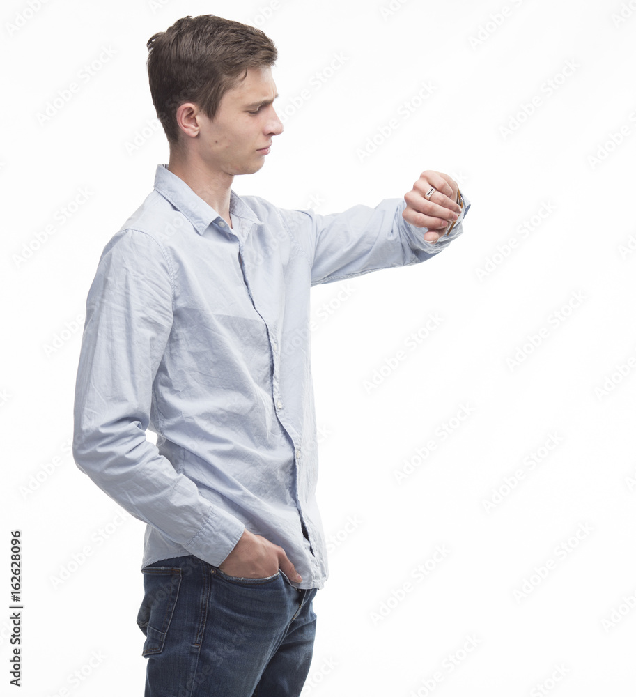 Young pensive man showing by hands on a gray background. Ideal for banners, registration forms, presentation, landings, presenting concept. Young pensive man showing by hands on a gray background. Ideal for banners, registration forms, presentation, landings, presenting concept.