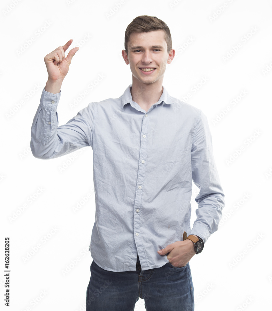 Young happy man showing by hands on a gray background. Ideal for banners, registration forms, presentation, landings, presenting concept. Young happy man showing by hands on a gray background. Ideal for banners, registration forms, presentation, landings, presenting concept.