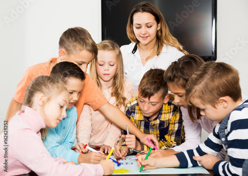 Team of elementary age children drawing
