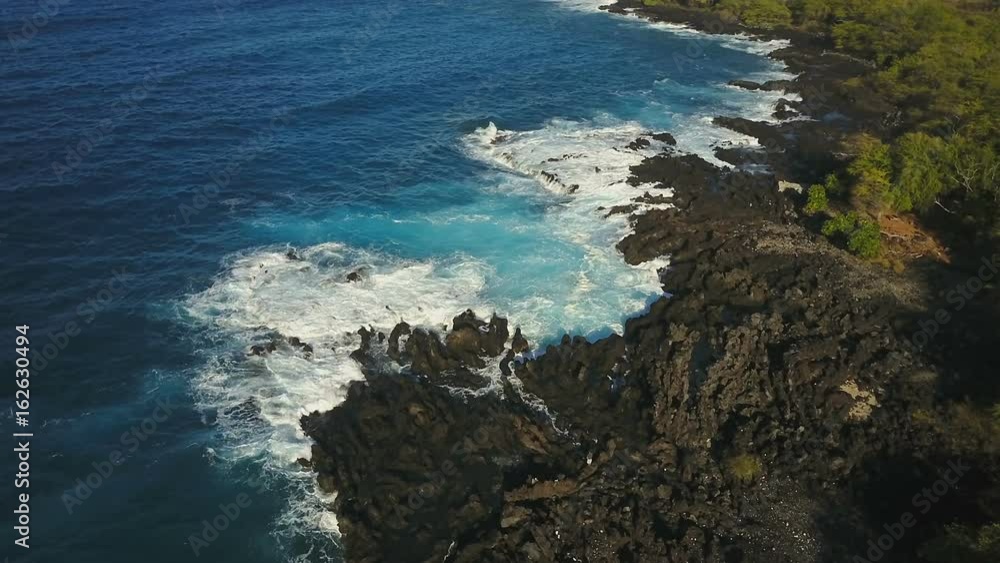 Aerial view of waves crashing into the rugged shoreline of the Big Island of Hawaii Aerial view of waves crashing into the rugged shoreline of the Big Island of Hawaii
