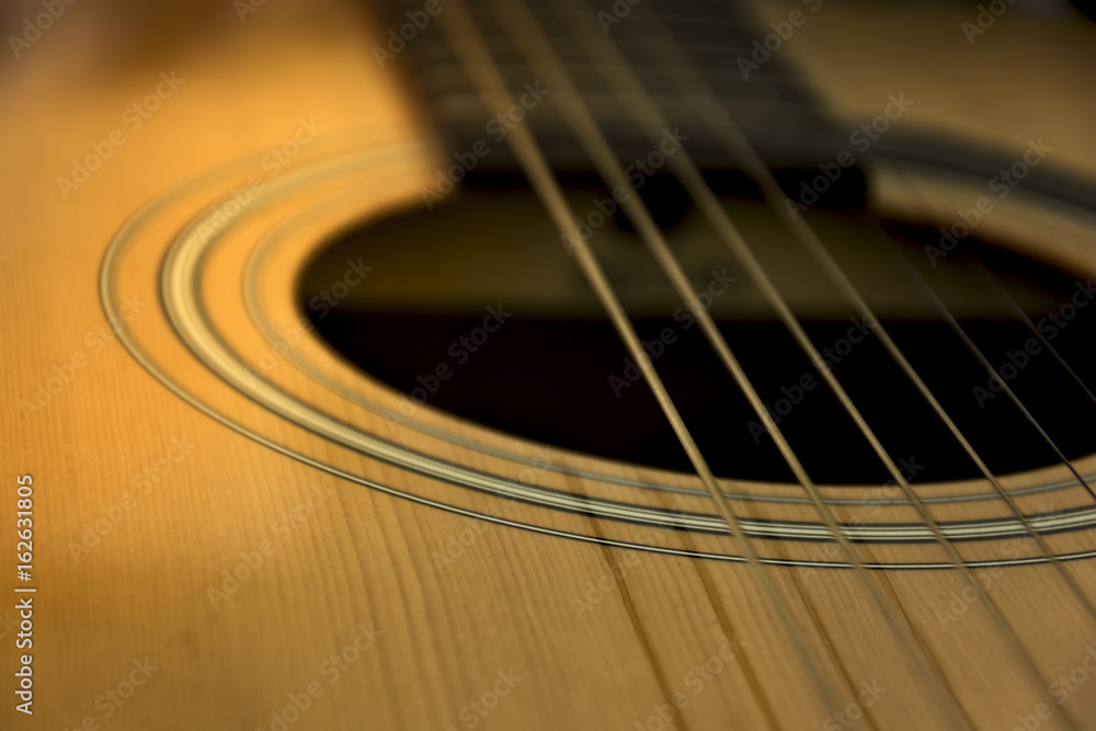 Detail of guitar. View on guitar strings. Wooden musical instrument. Detail of guitar. View on guitar strings. Wooden musical instrument.