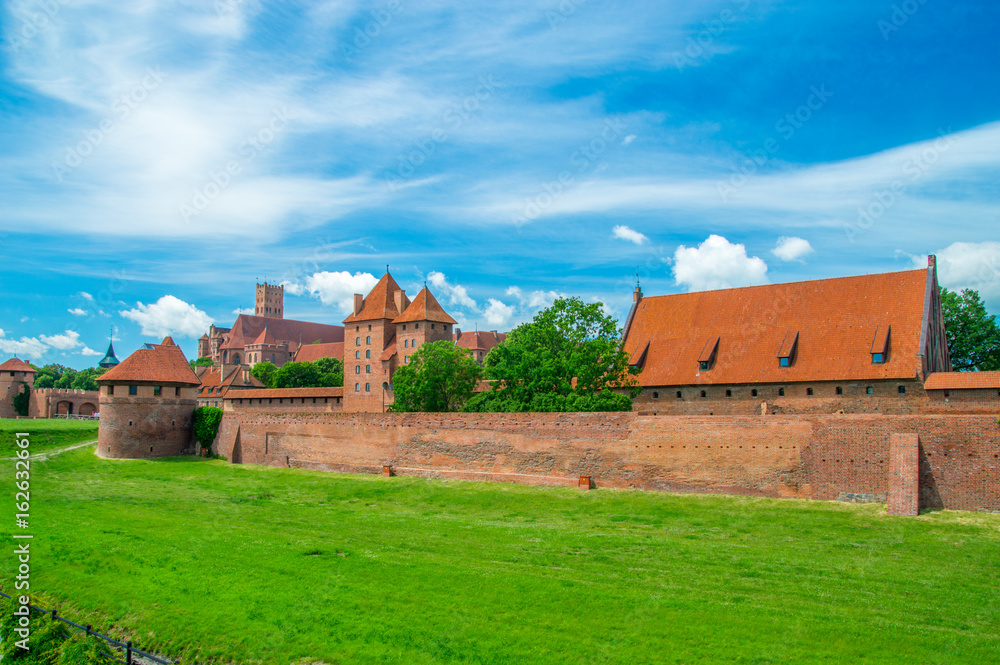 Castle fortifications of the Teutonic Order in Malbork from East. Malbork Castle is is the largest castle in the world measured by land area. Castle fortifications of the Teutonic Order in Malbork from East. Malbork Castle is is the largest castle in the world measured by land area.