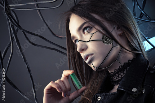 charming robot girl with cyberpunk style makeup holding battery in hand, concept energy saving