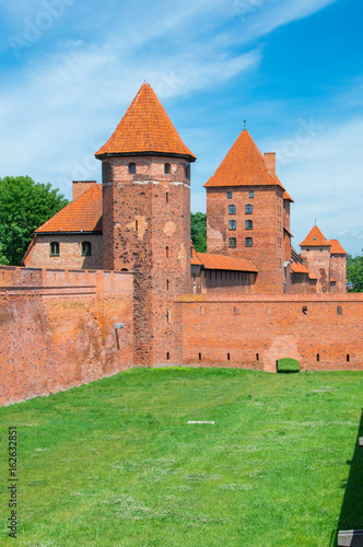 Castle fortifications of the Teutonic Order in Malbork from East. Malbork Castle is is the largest castle in the world measured by land area. photo