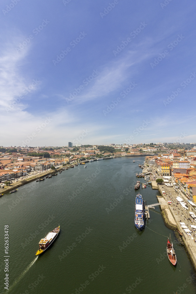 Porto landscape view over Douro River and tradicional Rabelo boats, on a summer day, Portugal.