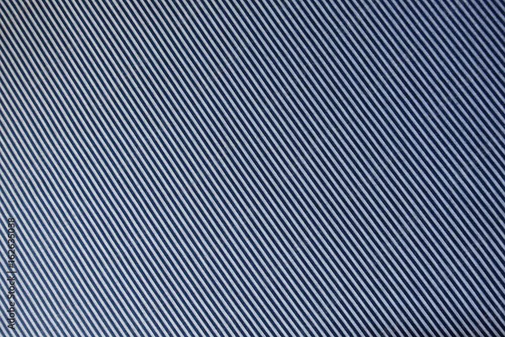 Striped white and blue fabric swatch (diagonal) from above Striped white and blue fabric swatch (diagonal) from above