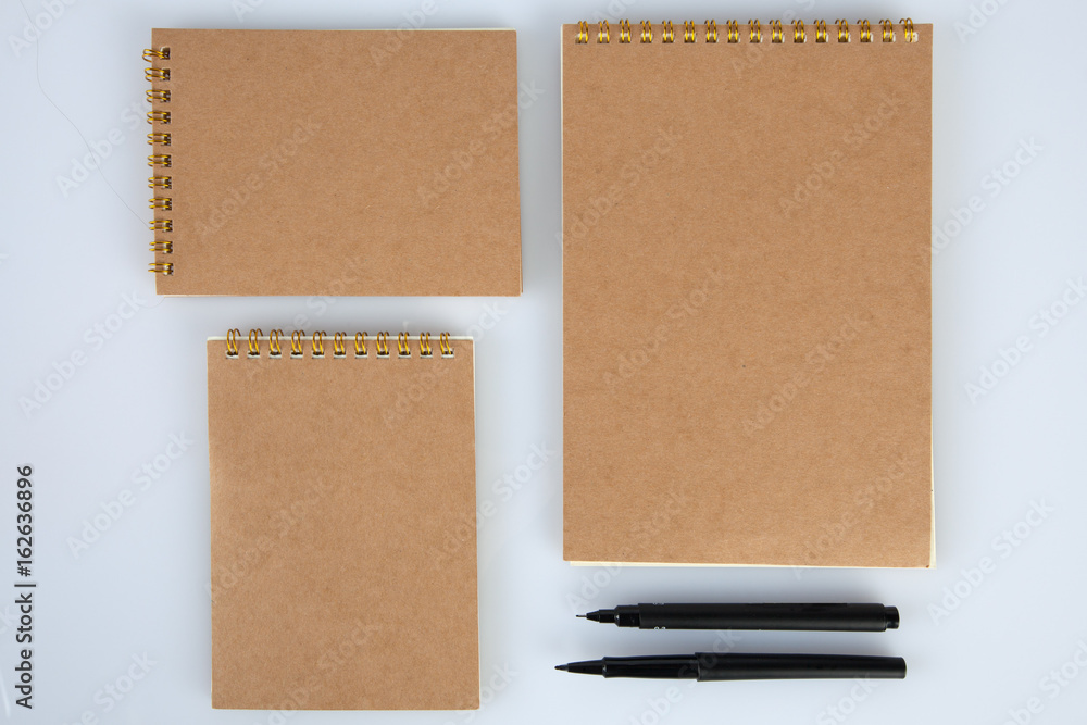 Set of notepads with black pens for mockups. Top view with copy space Set of notepads with black pens for mockups. Top view with copy space