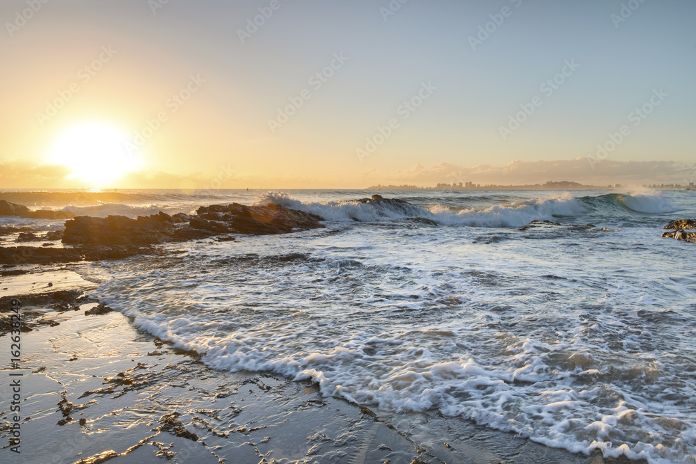 Ocean sunrise and surf hitting the rocks at Currumbin Rock, Gold Coast