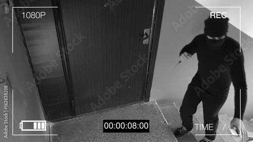 surveillance camera caught the robber in a mask with a knife.