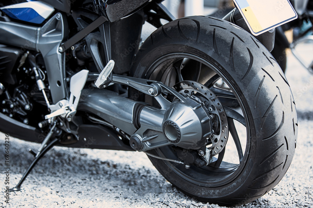 Motorcycle luxury items close-up: headlights, shock absorber, wheel, wing, toning. Motorcycle luxury items close-up: headlights, shock absorber, wheel, wing, toning.