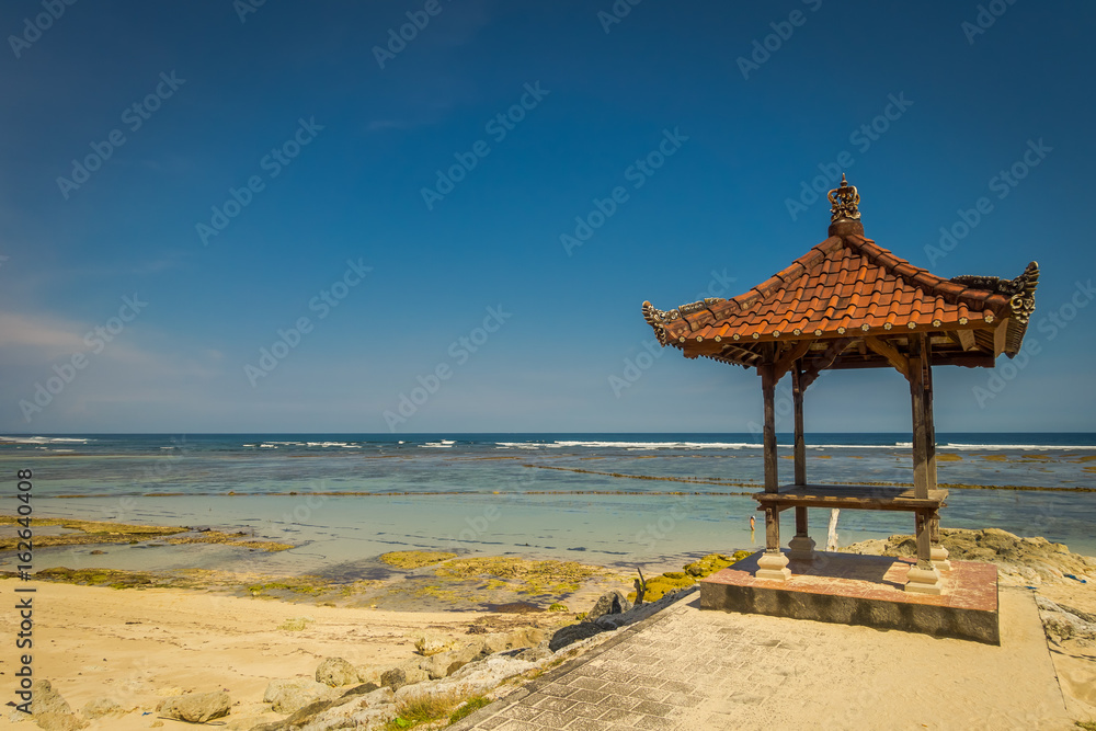 Beautiful sunny day with a small cabain in the beach of Pantai pandawa, in Bali island, Indonesia
