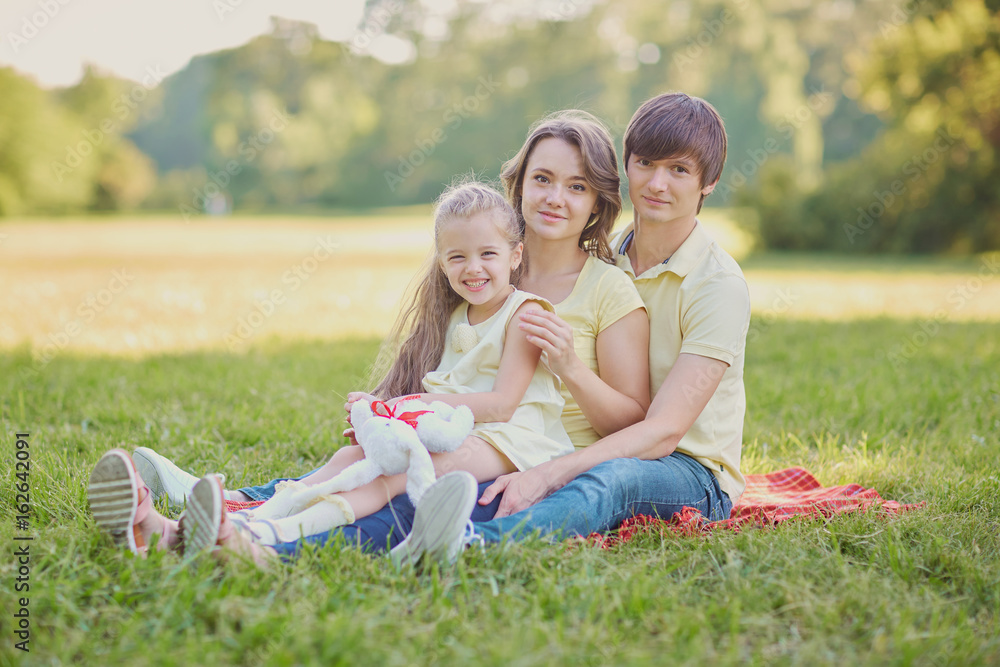 Happy family in the park on a sunny day. Happy family in the park on a sunny day.