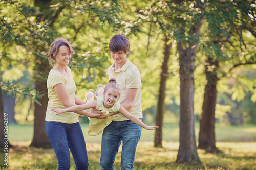 Happy family in the park on a tree background. © Studio Romantic
