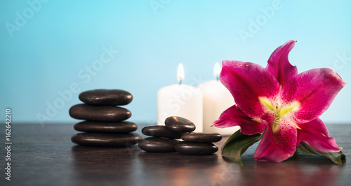 Nature products Spa and wellness setting with flowers  towels  stones and candle