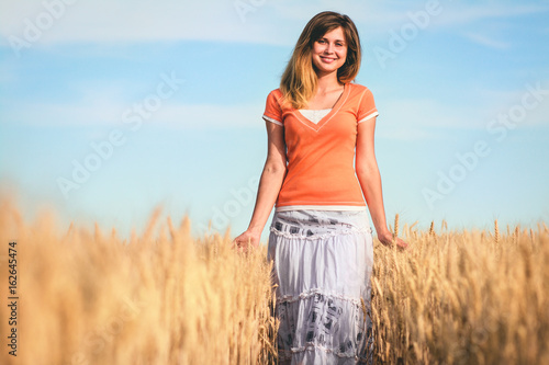Portrait of a woman walking in the nature in a field