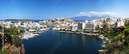 Panoramic view of Lake Voulismeni in Agios Nikolaos, Crete, Greece. A beautiful coastal city with colorful buildings.