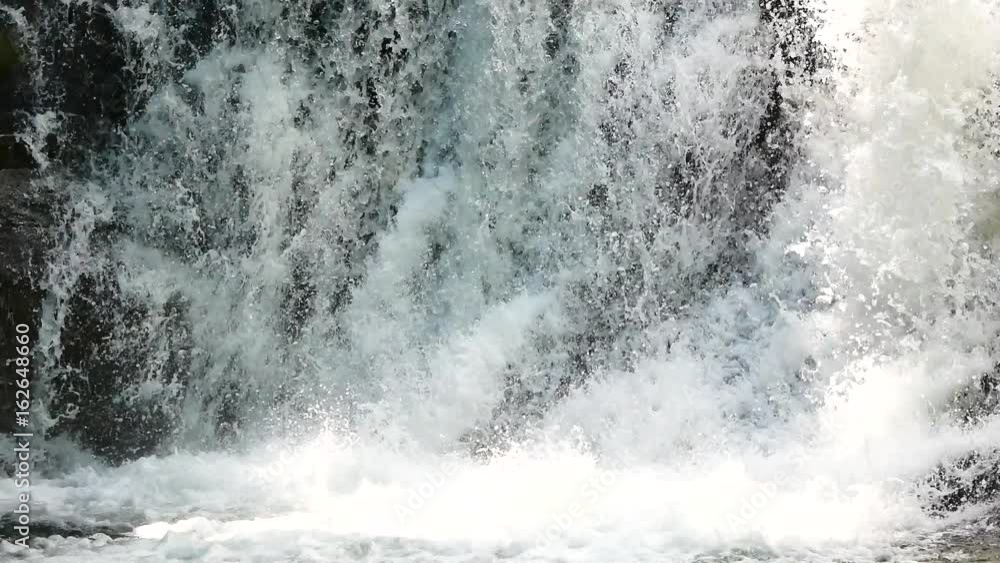 Close up Waterfalls in the rainy season. There is a lot of water flowing into the stones. In the forests of the National Park, include The sound of waterfall. Close up Waterfalls in the rainy season. There is a lot of water flowing into the stones. In the forests of the National Park, include The sound of waterfall.