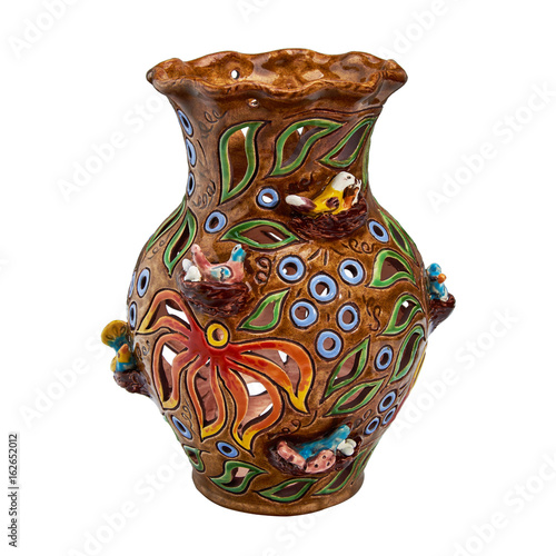 Colorful decorative handmade vase decorated with flowers. Isolated on a white background