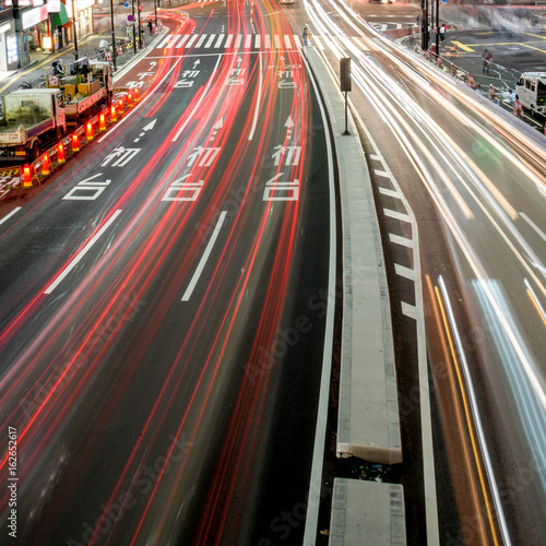 Busy night traffic on the road through business district avenue in Tokyo, Japan