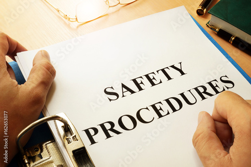 Safety procedures in a blue folder. Work Safety concept.